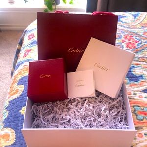 Cartier boxes, bag, and perfume samples